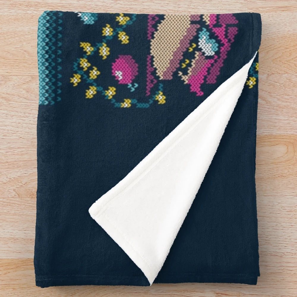 Plush blanket featuring an "ugly" Christmas sweater design inspired by the classic National Lampoon's Vacation movie