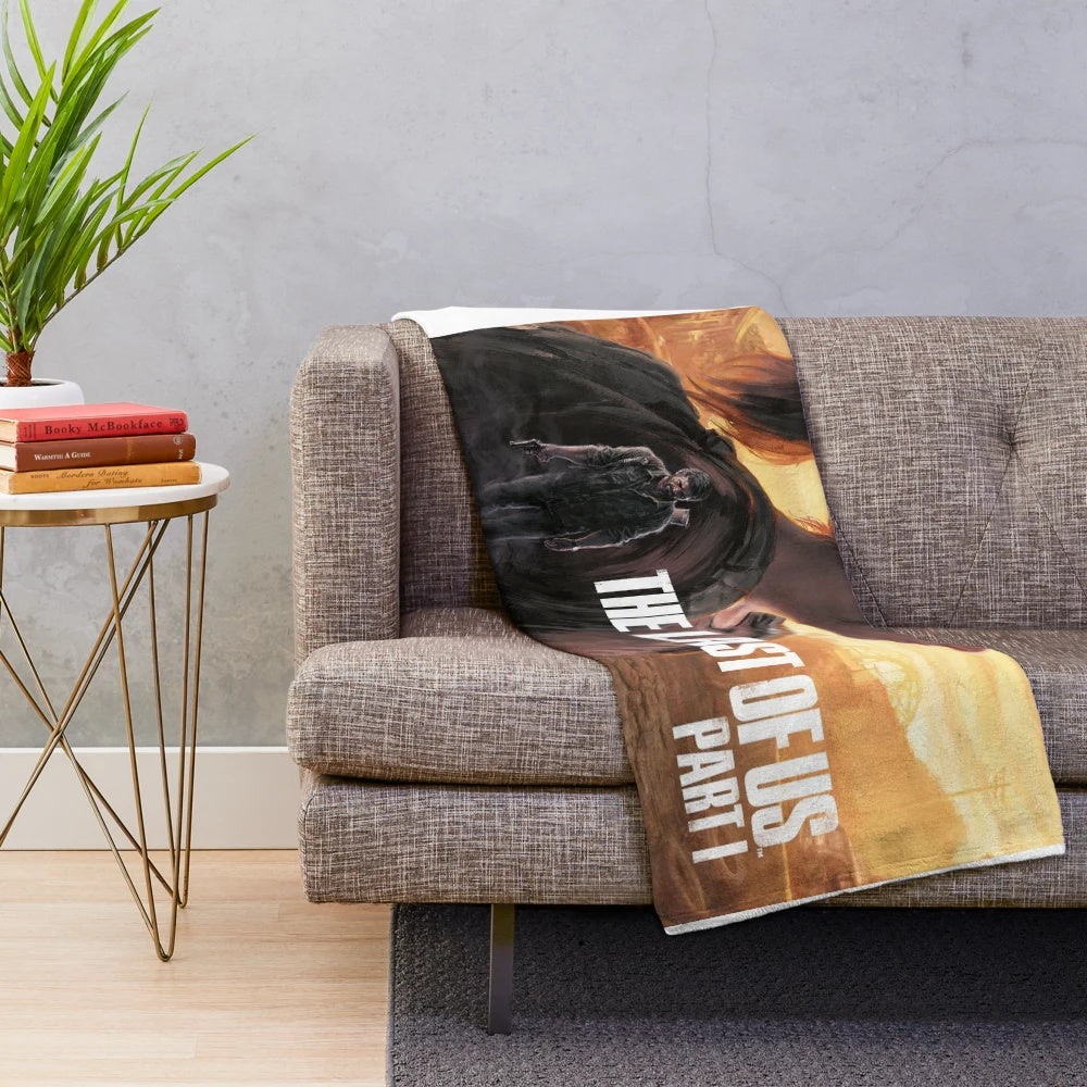 Plush blanket with The Last of Us inspired design featuring Ellie and Joel