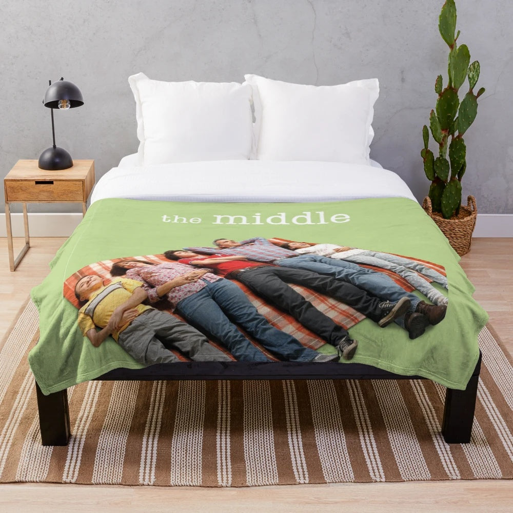 Plush blanket featuring characters and imagery from the TV show The Middle