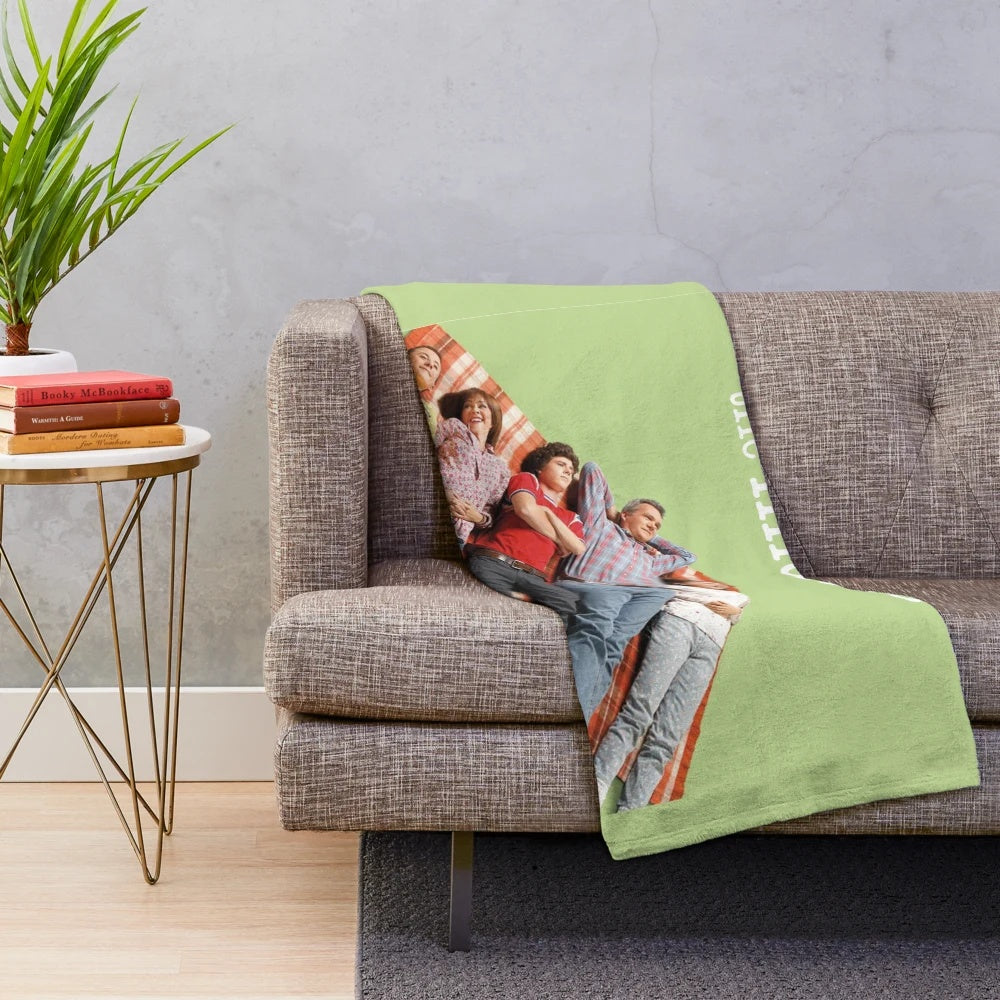 Plush blanket featuring characters and imagery from the TV show The Middle