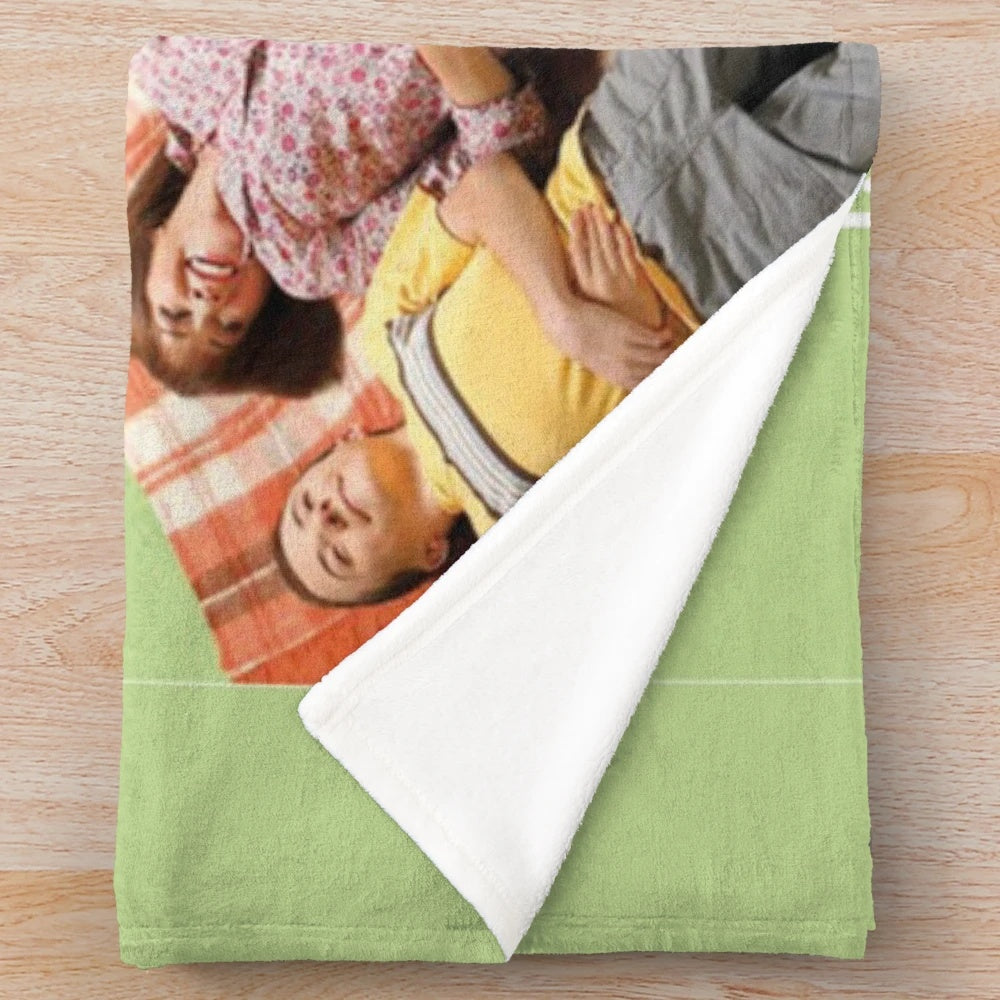 Plush blanket featuring characters and imagery from the TV show The Middle