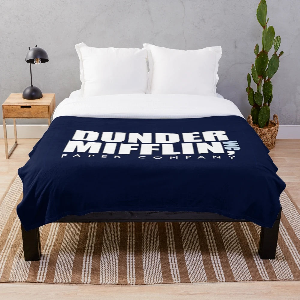 Plush blanket featuring The Office TV show logo and characters