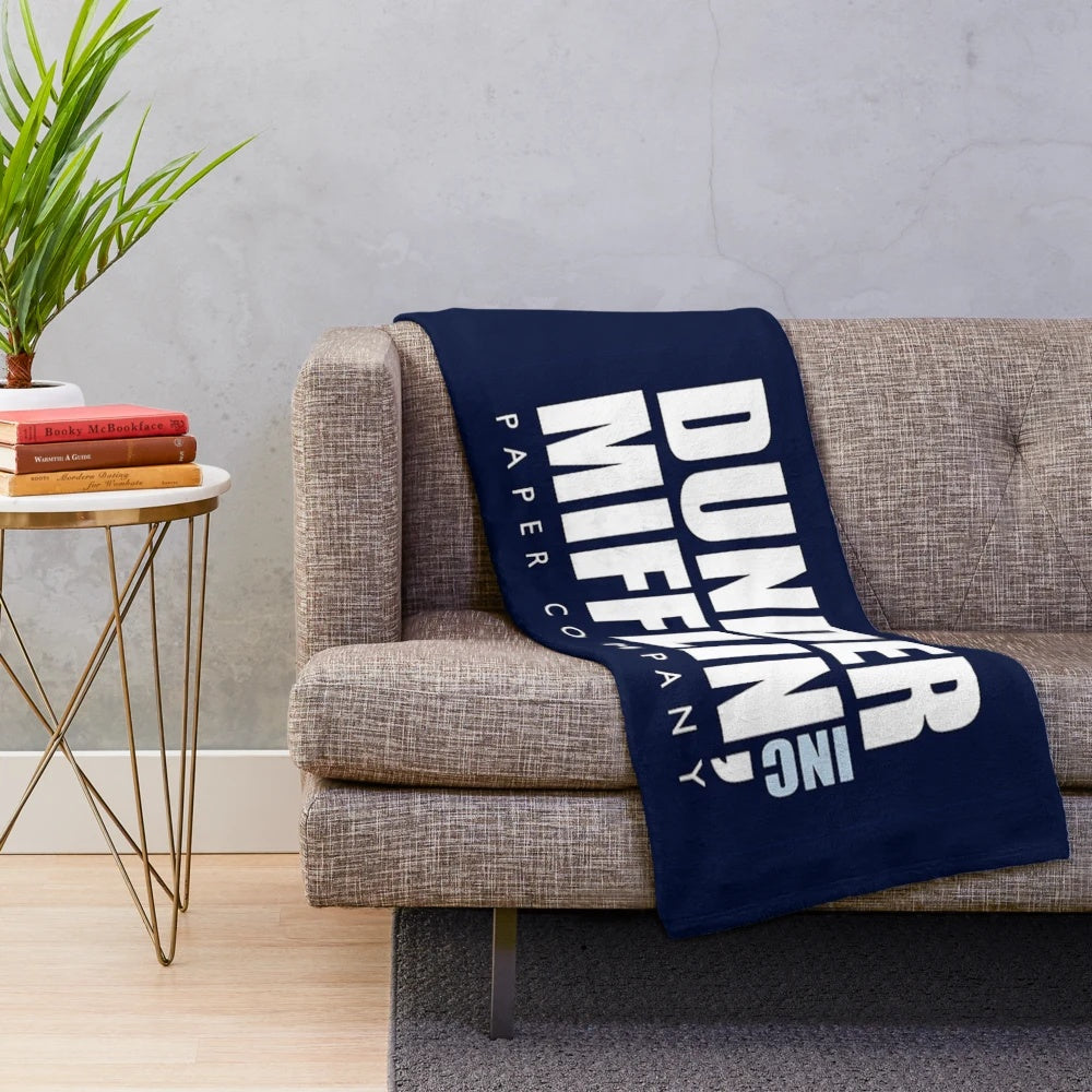 Plush blanket featuring The Office TV show logo and characters