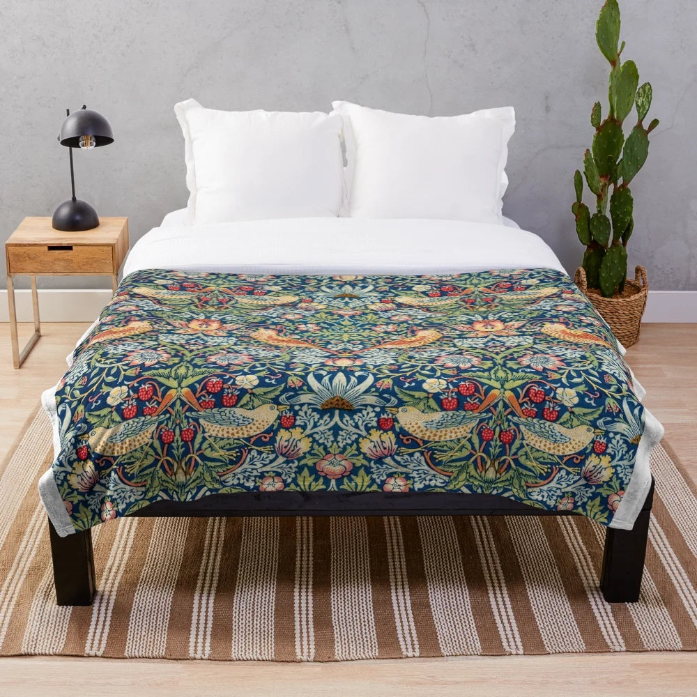 Closeup of the Strawberry Thief plush blanket featuring a floral and bird pattern