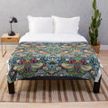 Closeup of the Strawberry Thief plush blanket featuring a floral and bird pattern