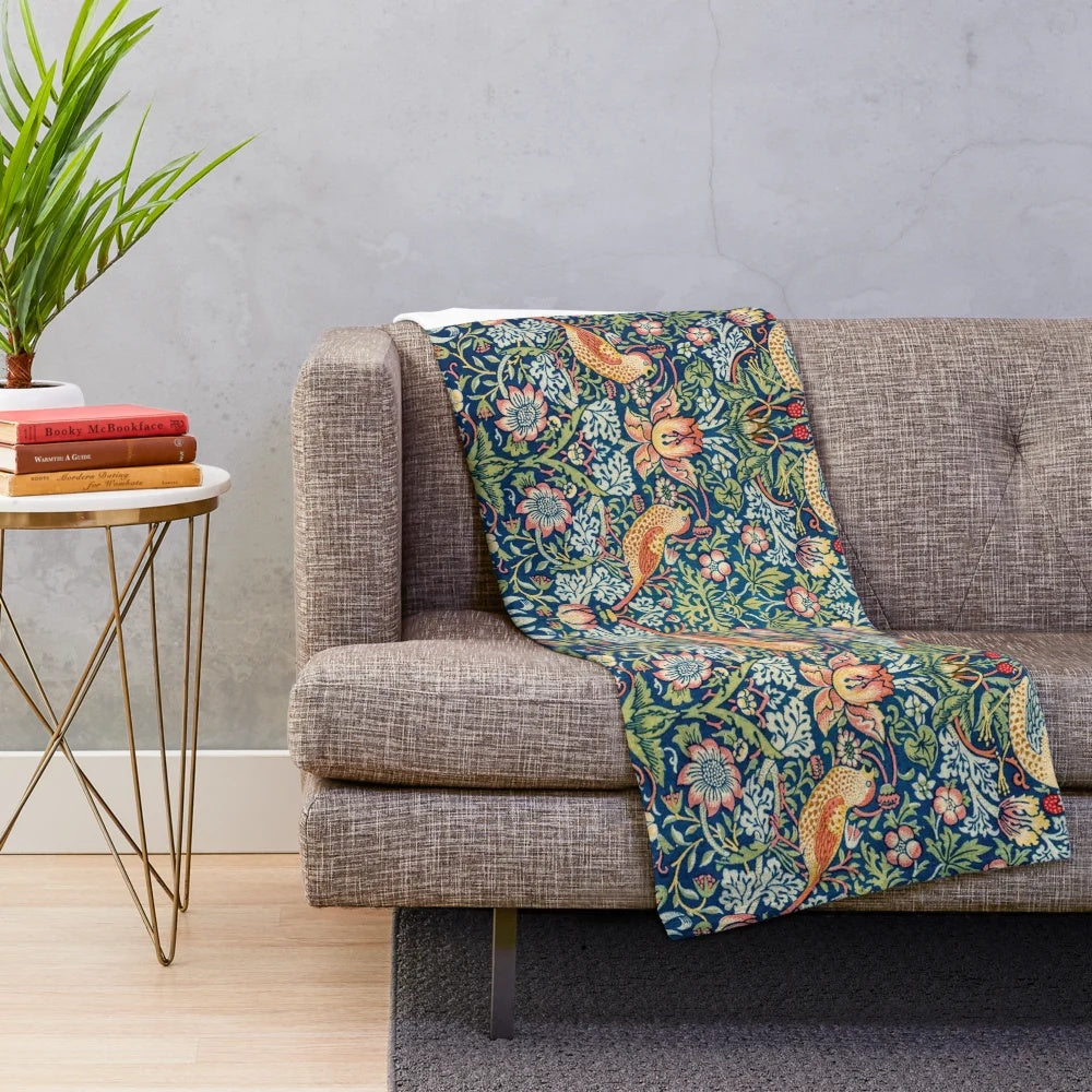 Closeup of the Strawberry Thief plush blanket featuring a floral and bird pattern
