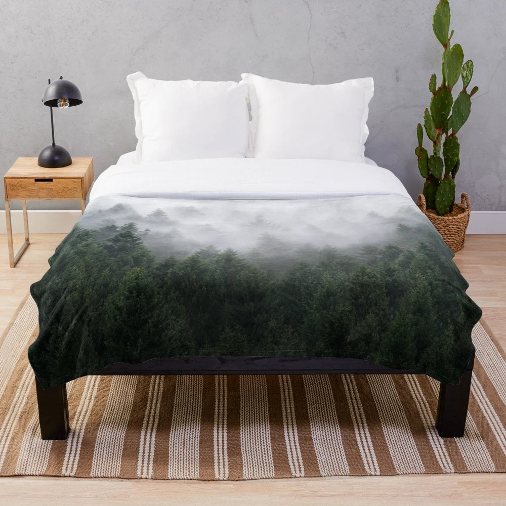 Plush blanket with a misty, fairytale-like forest design