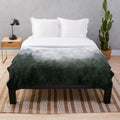 Plush blanket with a misty, fairytale-like forest design