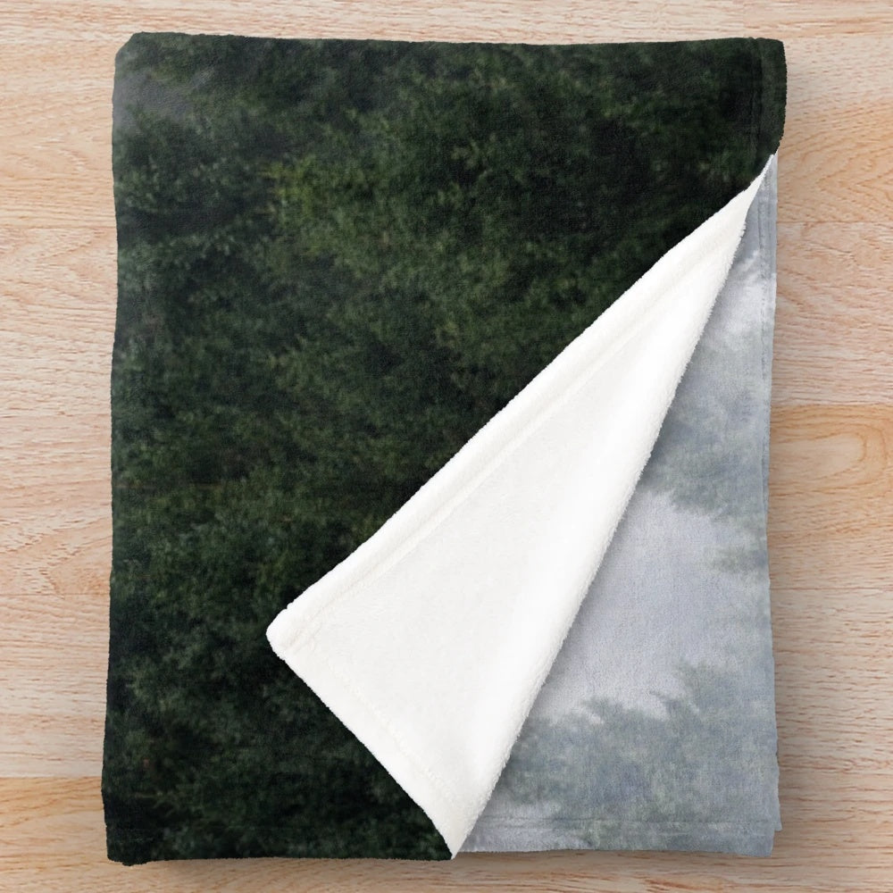 Plush blanket with a misty, fairytale-like forest design