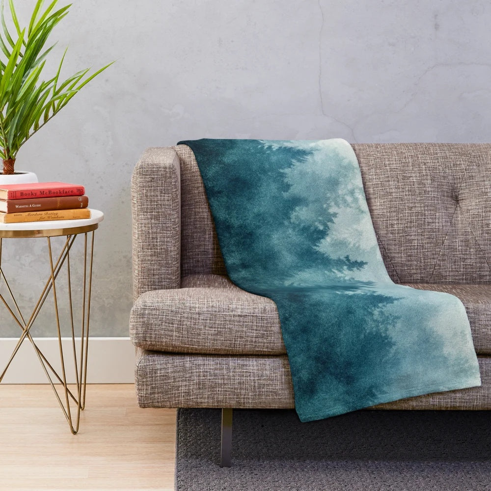 Plush blanket featuring a dreamy, foggy forest landscape