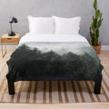 Plush blanket featuring a misty, foggy forest scene with Cascadia trees