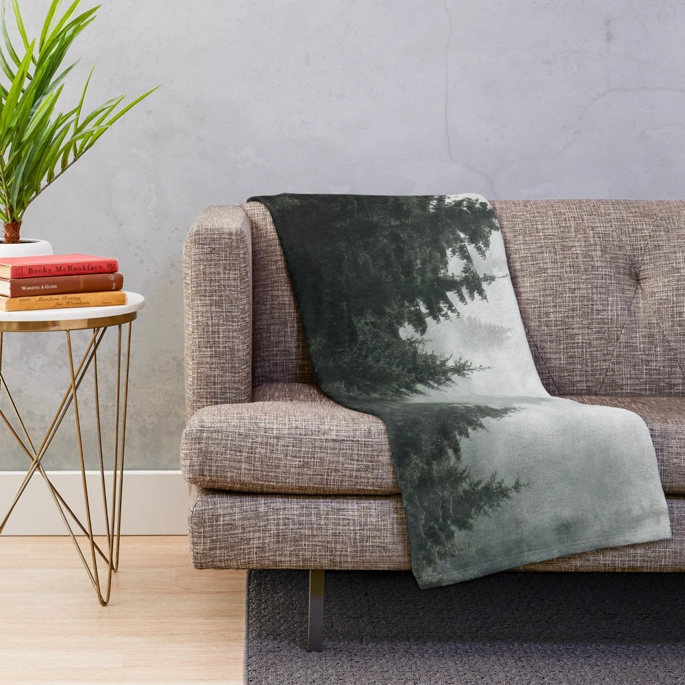 Plush blanket featuring a misty, foggy forest scene with Cascadia trees
