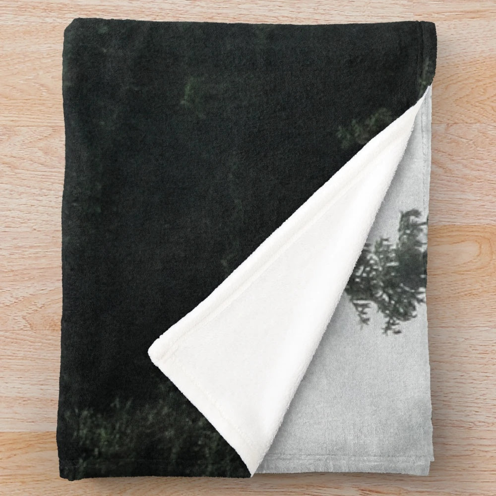 Plush blanket featuring a misty, foggy forest scene with Cascadia trees