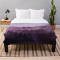 Plush blanket with a dreamy, moody forest landscape design