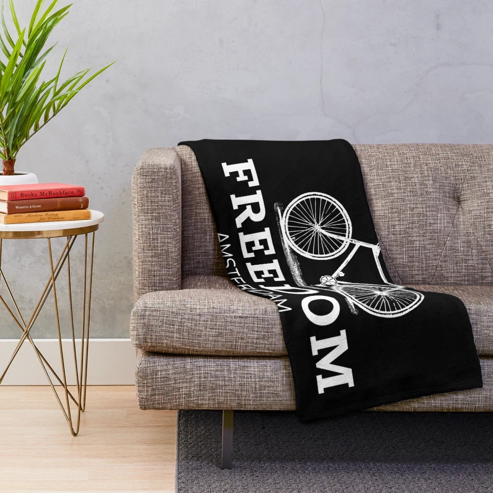 Plush blanket featuring a cyclist riding a bicycle through the streets of Amsterdam