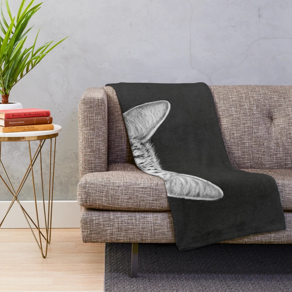 Plush blanket with black and white animal print design