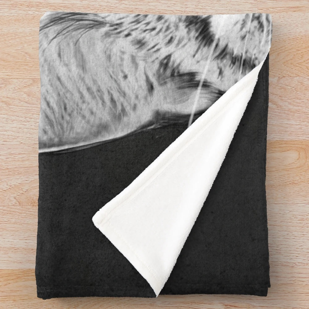 Plush blanket with black and white animal print design