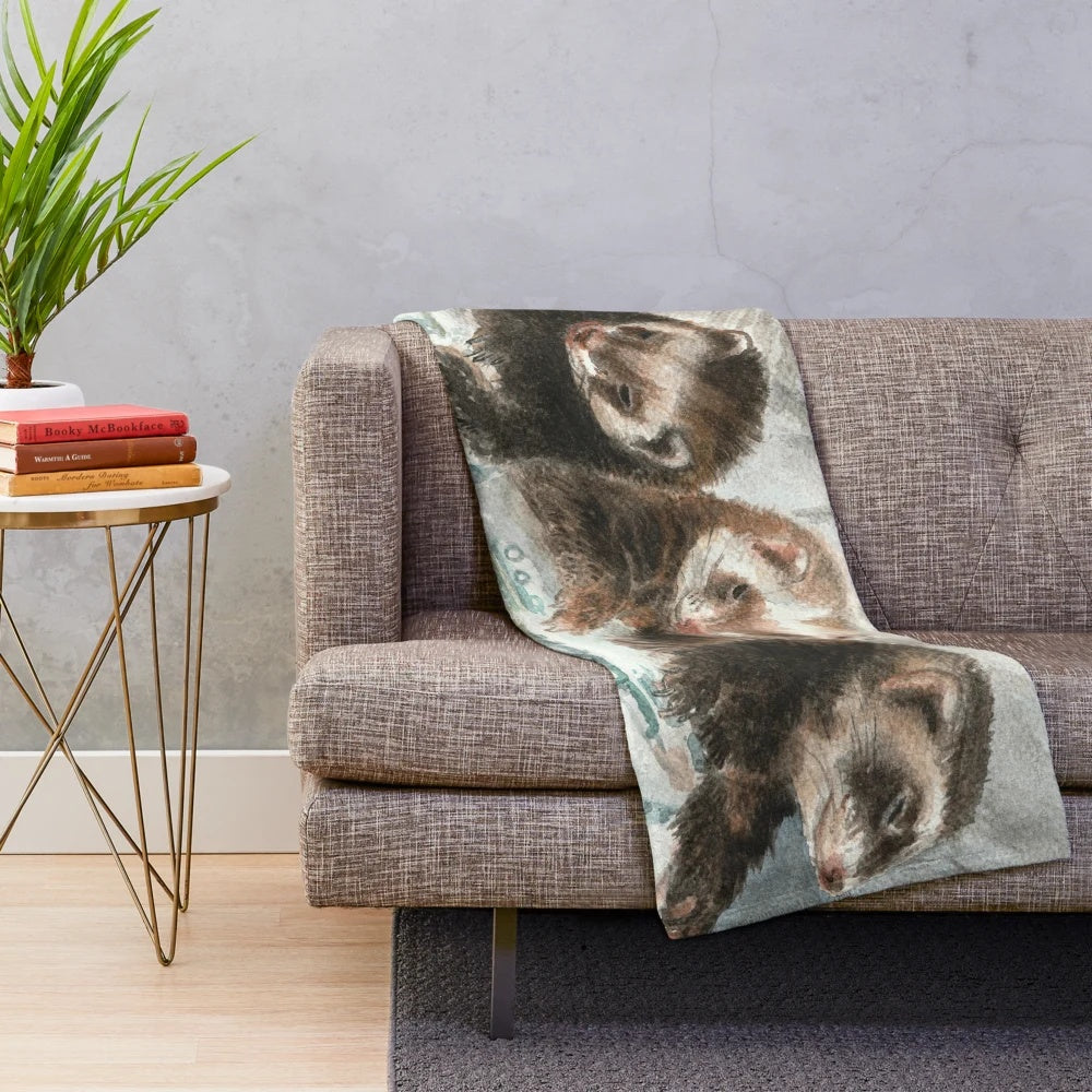 Plush blanket with a watercolor design of a cute ferret
