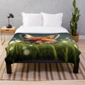 A cozy and soft plush blanket featuring an illustration of a fox in a colorful grassy field