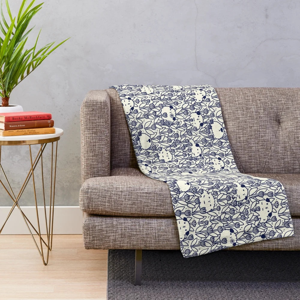 Soft and cuddly plush blanket featuring a charming navy blue and ivory guinea pig and flower pattern design
