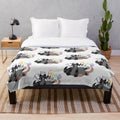 Soft plush blanket featuring opossum and raccoon designs