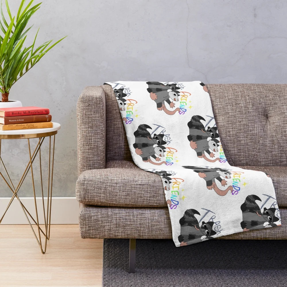 Soft plush blanket featuring opossum and raccoon designs