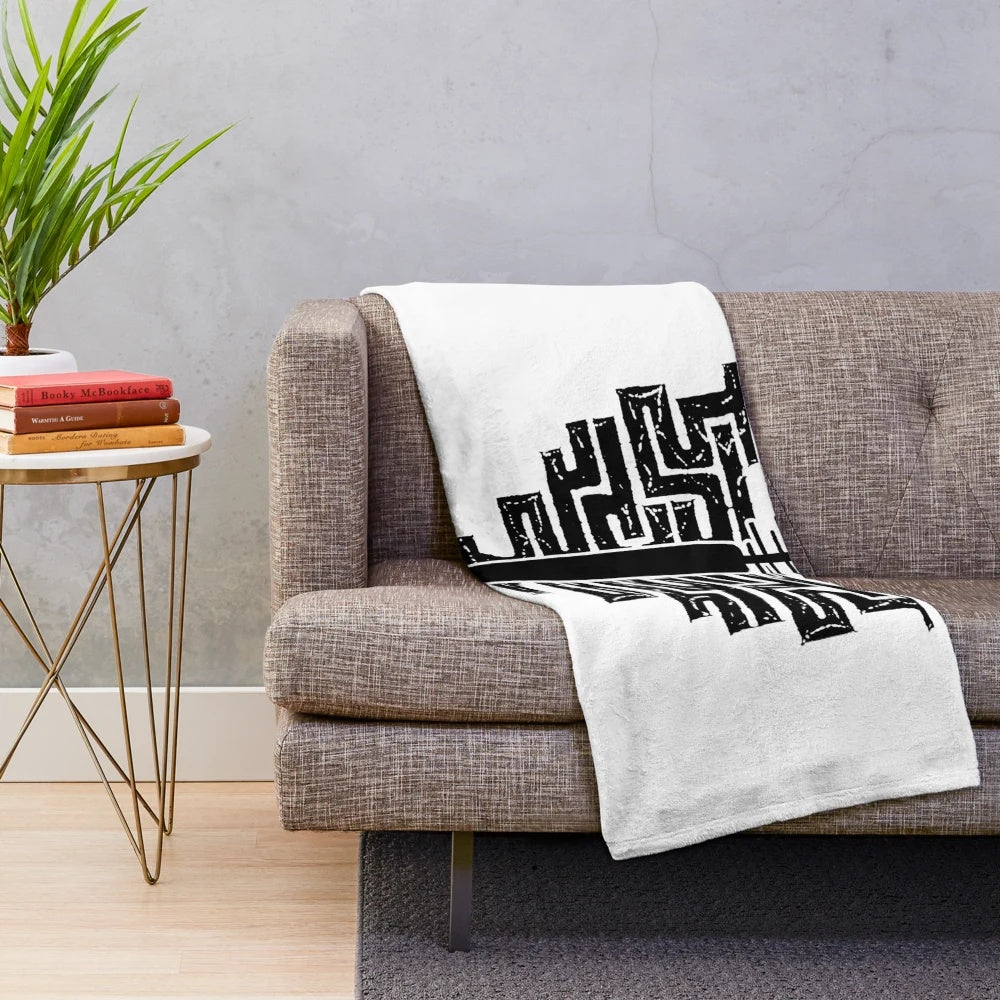 Cozy plush blanket featuring an Ainu-inspired amip design and tonkori silhouette