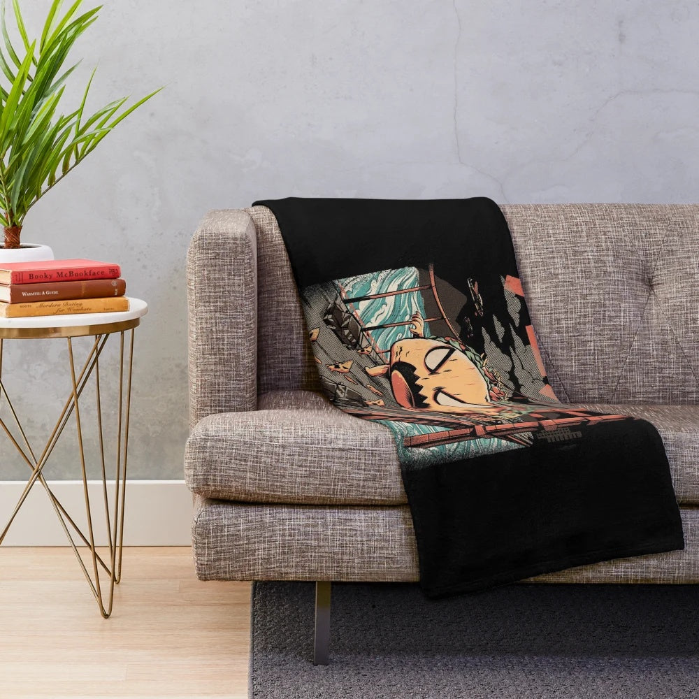 A cozy black and white plush blanket with an anime-inspired kaiju monster design