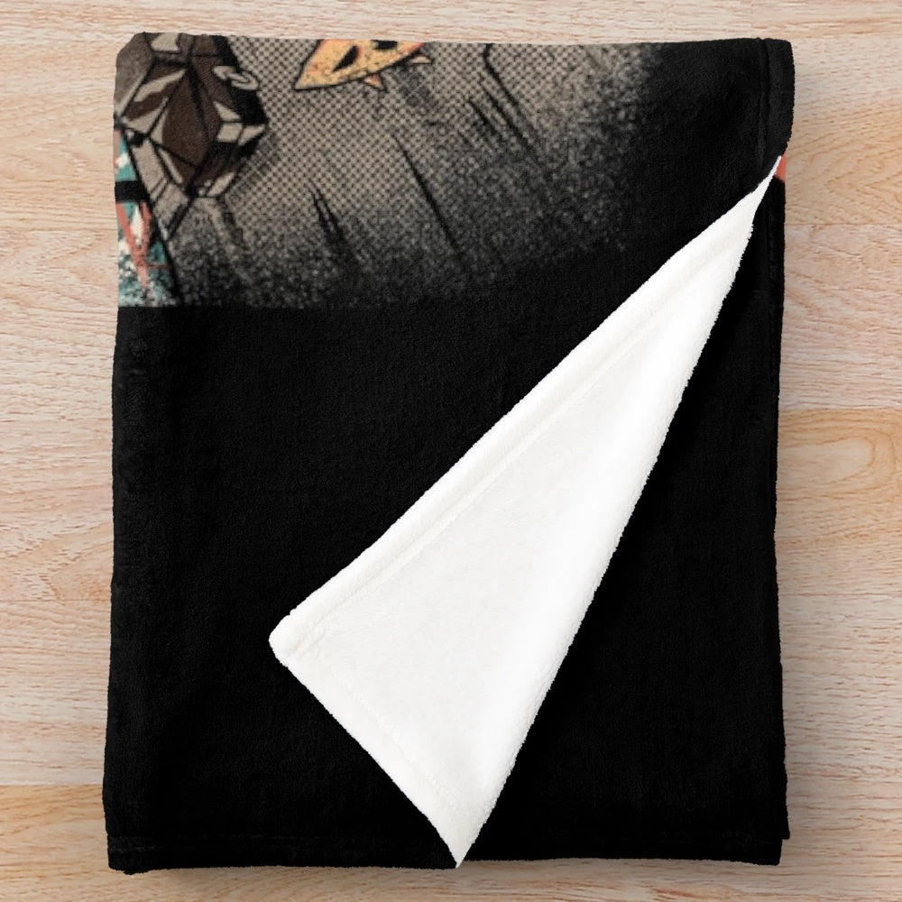 A cozy black and white plush blanket with an anime-inspired kaiju monster design