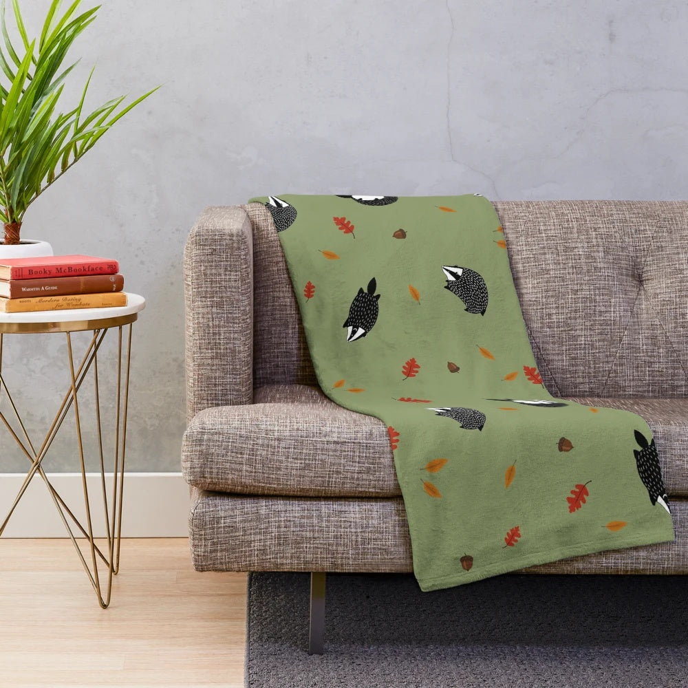 Plush blanket featuring a badger in a fall forest scene