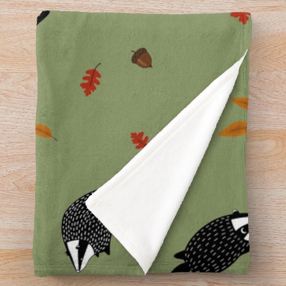 Plush blanket featuring a badger in a fall forest scene