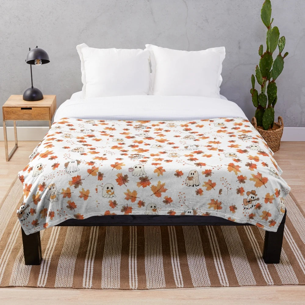 Cozy plush blanket featuring autumn-themed ghost designs