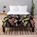 Plush blanket with abstract fall leaves and dull color palette