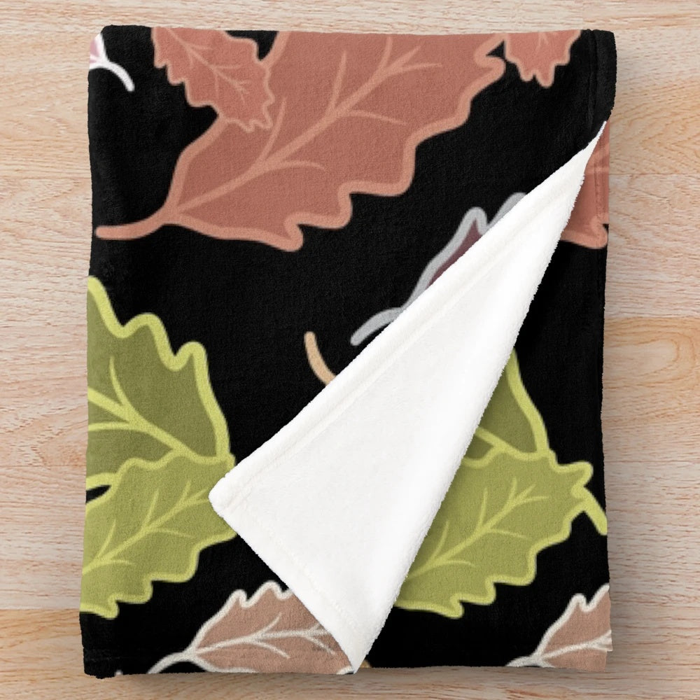 Plush blanket with abstract fall leaves and dull color palette