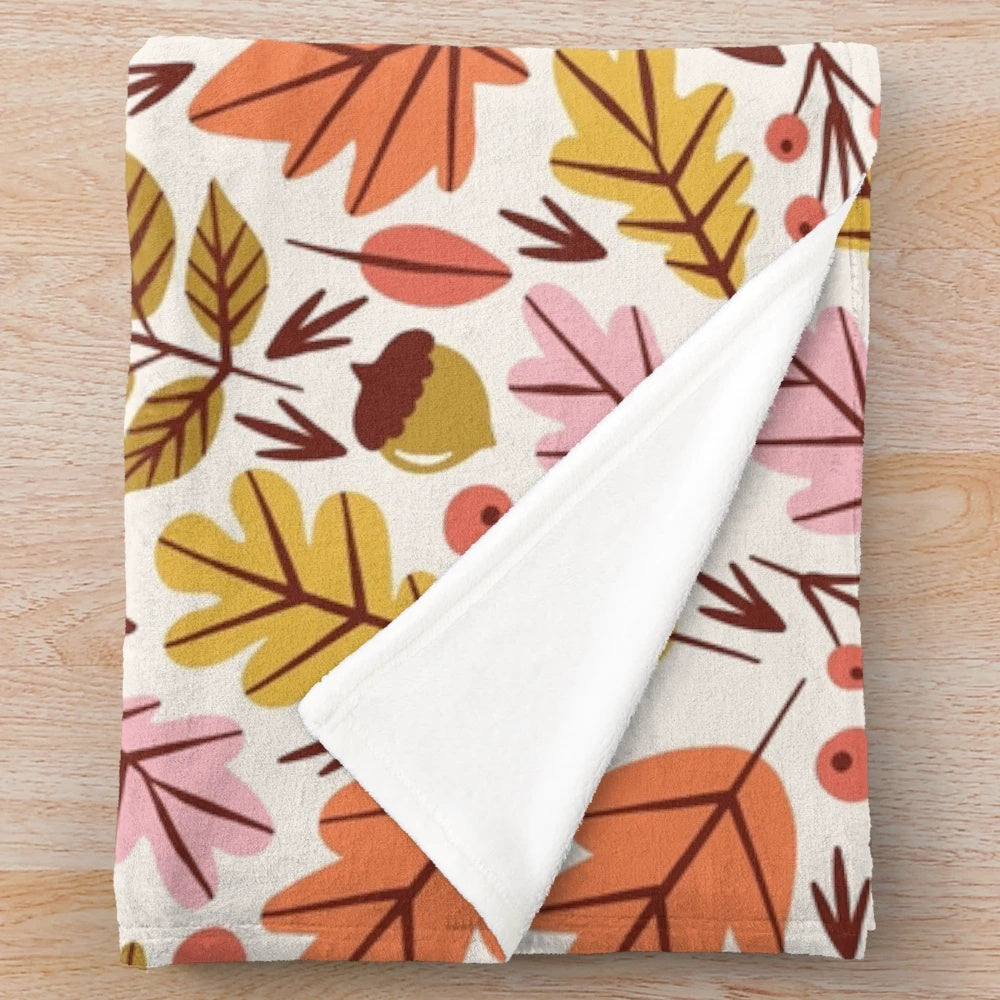 Cozy plush blanket with autumn leaves and acorn pattern