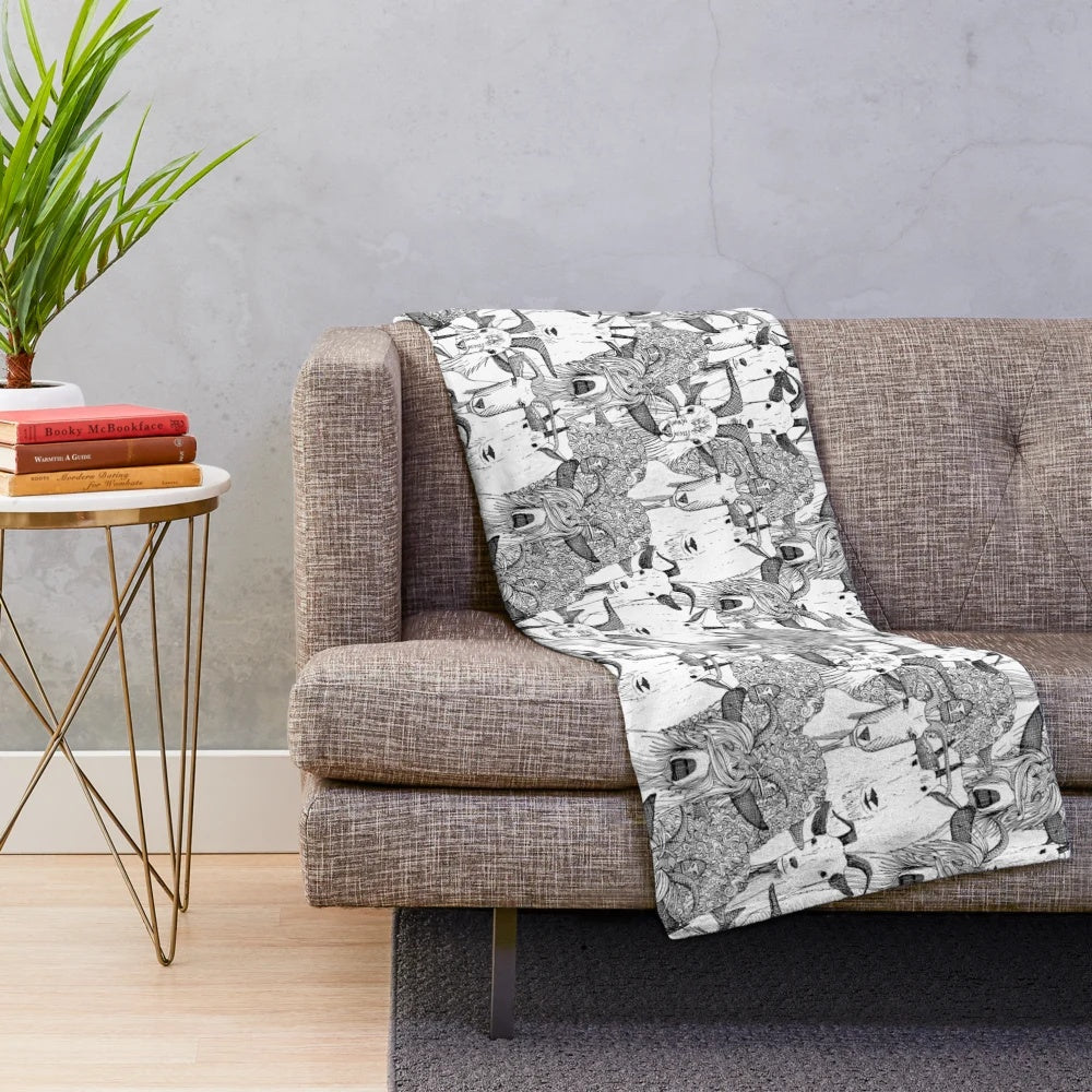 Plush blanket with a black and white goat pattern