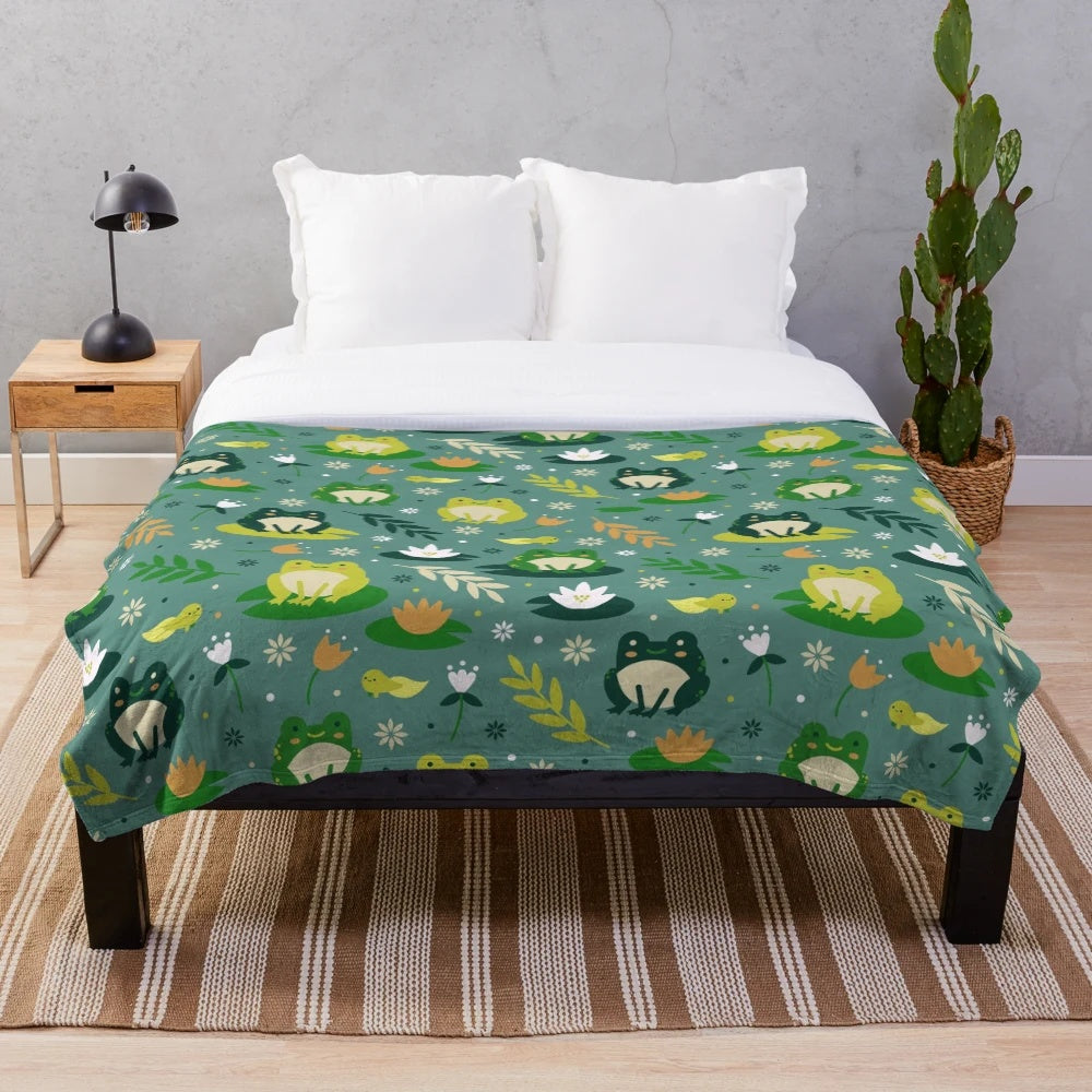 Plush blanket featuring a cute and vibrant frog pattern design