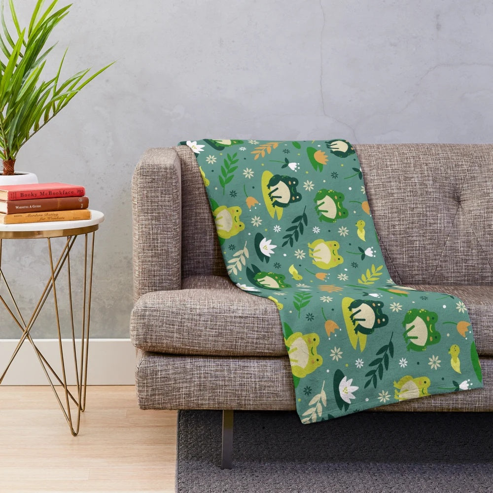 Plush blanket featuring a cute and vibrant frog pattern design