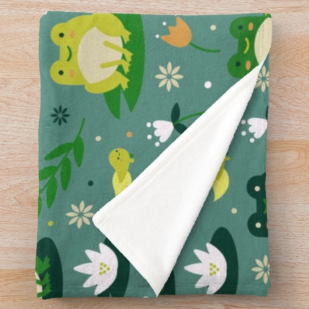Plush blanket featuring a cute and vibrant frog pattern design