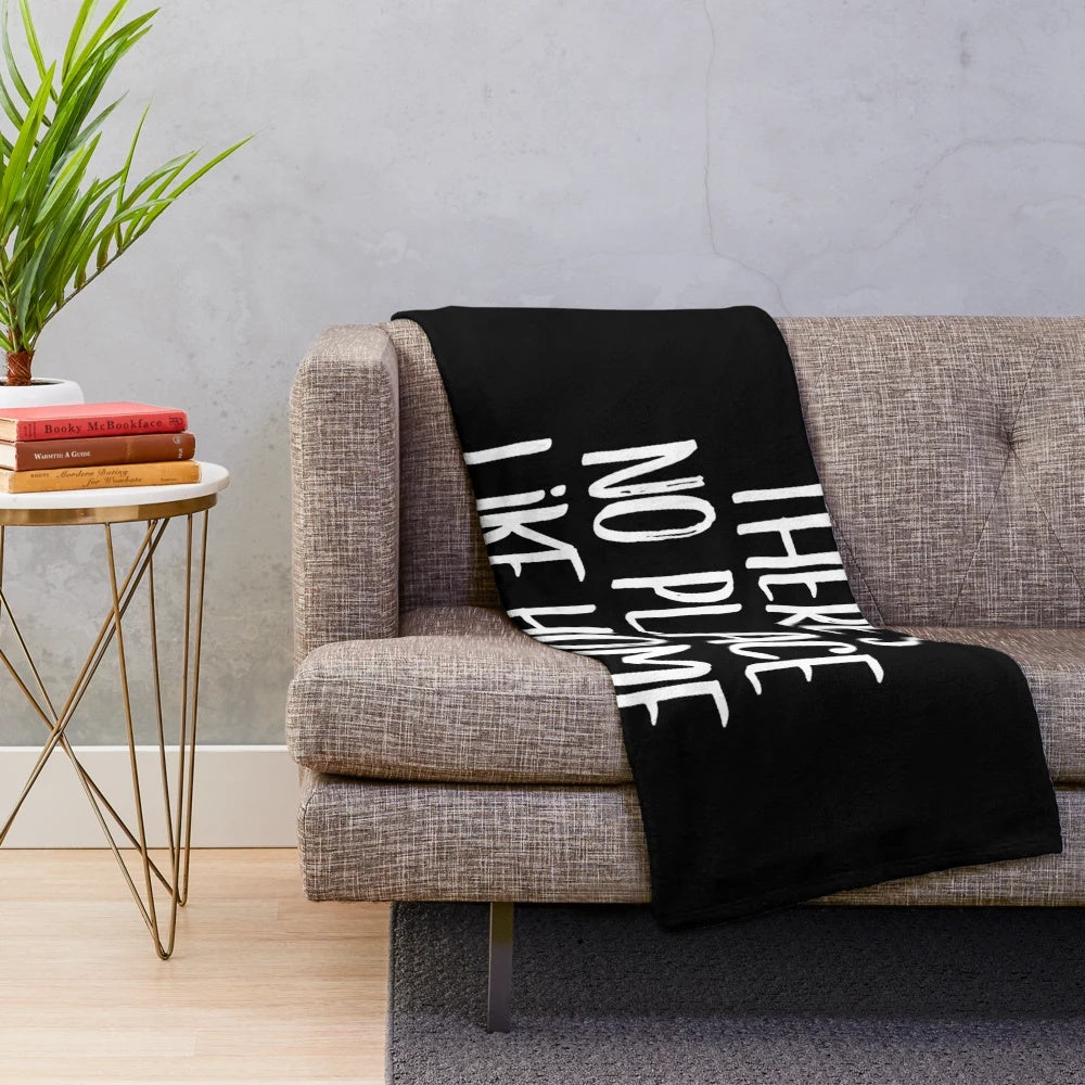 Soft, white plush blanket with "No place like home" quote