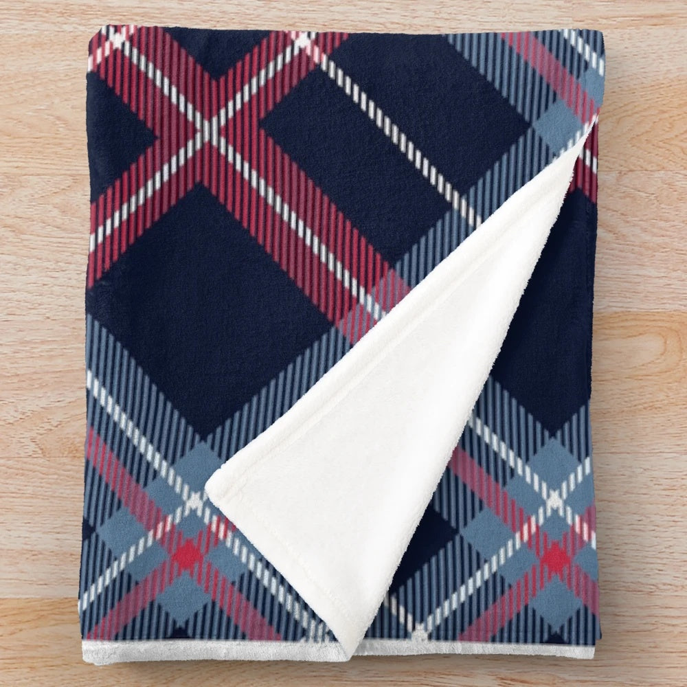 Plush blanket with traditional Scottish tartan pattern in navy blue