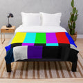 Plush blanket with vibrant TV color bars on white background