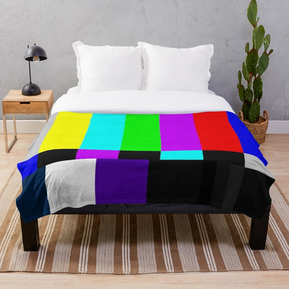 Plush blanket with vibrant TV color bars on white background