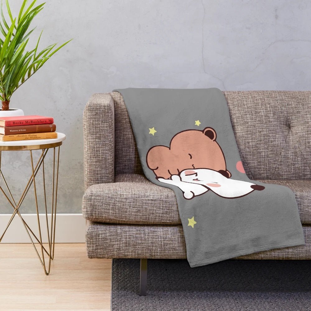 Plush blanket featuring a cute cartoon couple of a bear and panda bear hugging