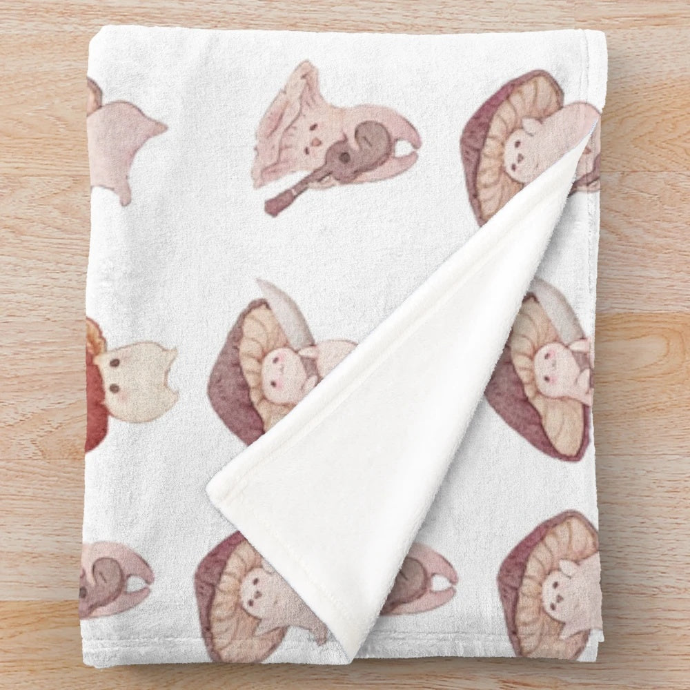 Plush blanket with four adorable mushroom characters in a fairy tale design