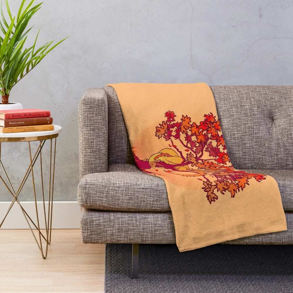 Plush blanket with a whimsical fall dragon design amid autumn leaves