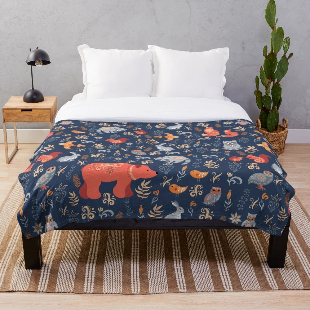 Plush blanket featuring a fairy-tale forest scene with woodland animals and floral patterns