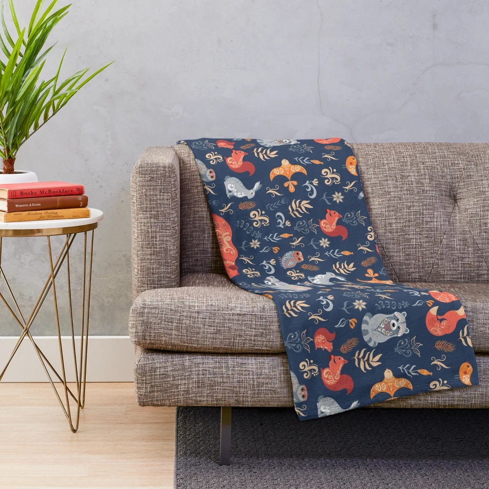 Plush blanket featuring a fairy-tale forest scene with woodland animals and floral patterns