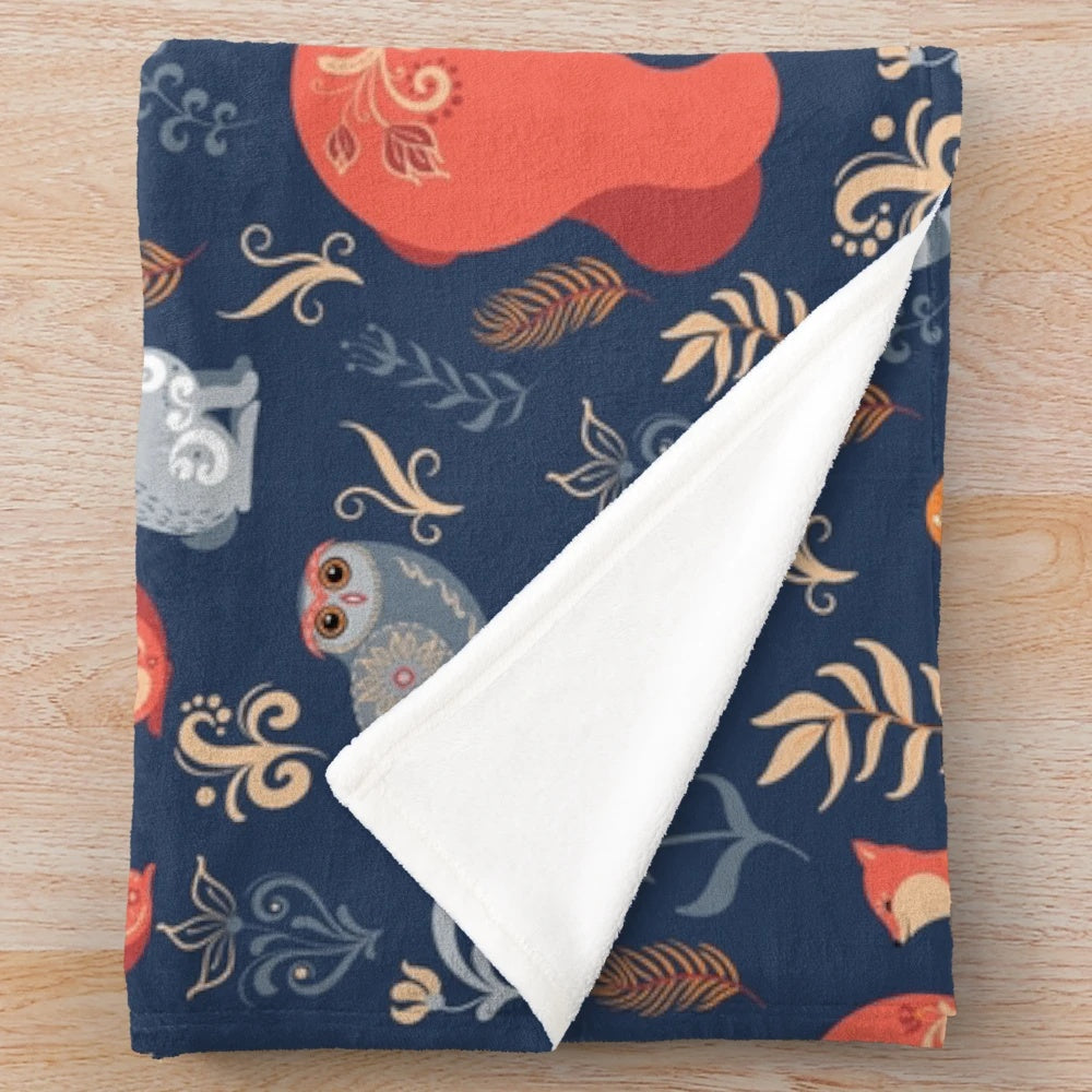 Plush blanket featuring a fairy-tale forest scene with woodland animals and floral patterns