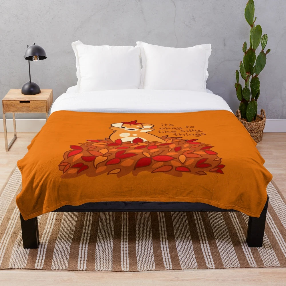 Plush blanket with fall leaves and puppy design